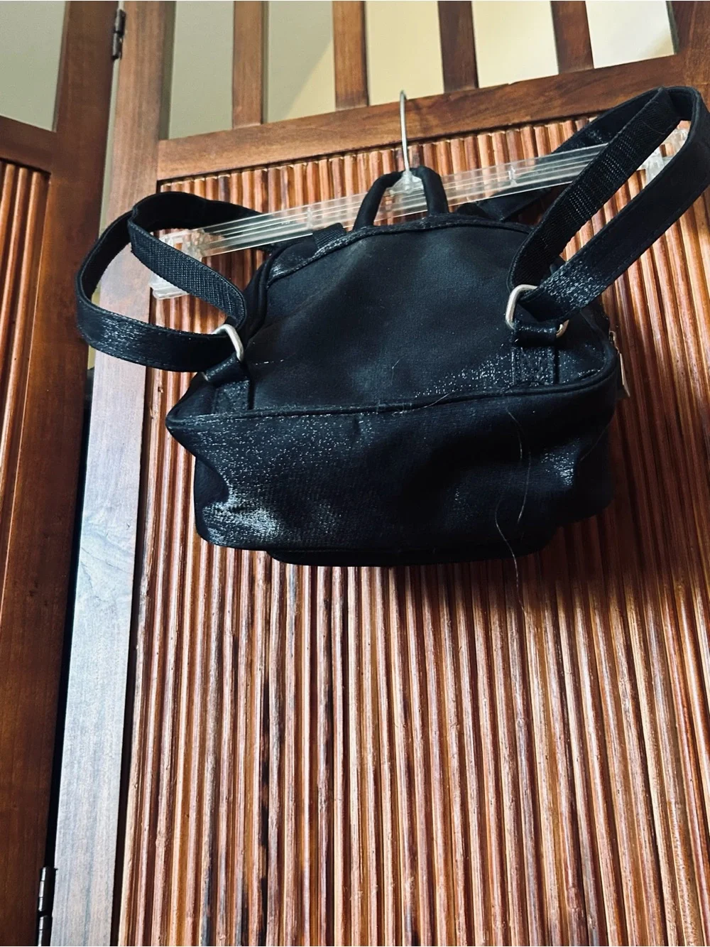 Backpack mini style. Black little purse with lots of compartments and zippers.